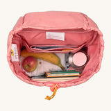 A close up of the Lassig kids mini adventure backpack in rose showing the space inside the main compartment and toggle detail for closing.