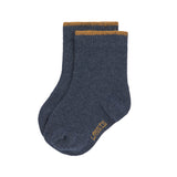 The Lassig organic cotton baby socks in navy blue with a mustard yellow trim on the cuffs.