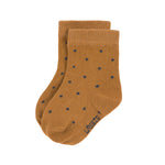 The Lassig organic cotton baby socks in mustard yellow with navy blue dots.