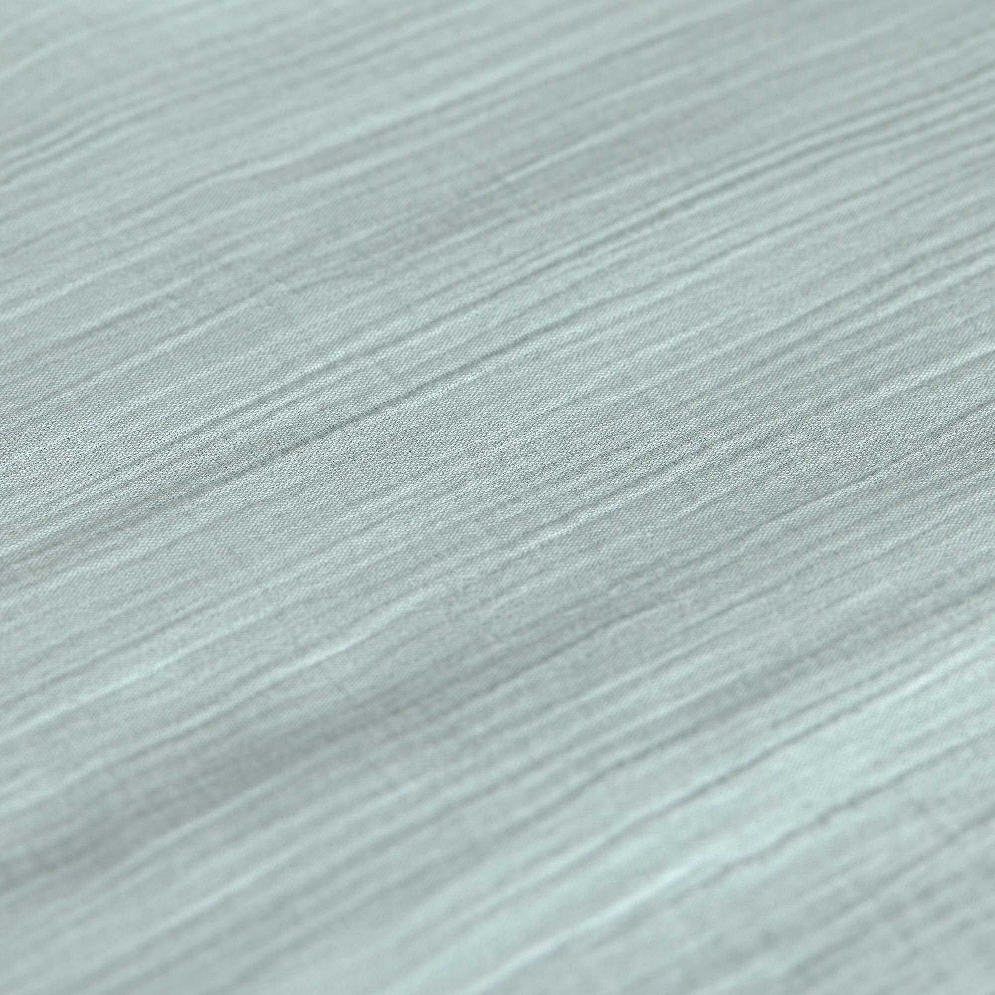 A closeup of the Lassig organic cotton muslin fabric, in a silver grey