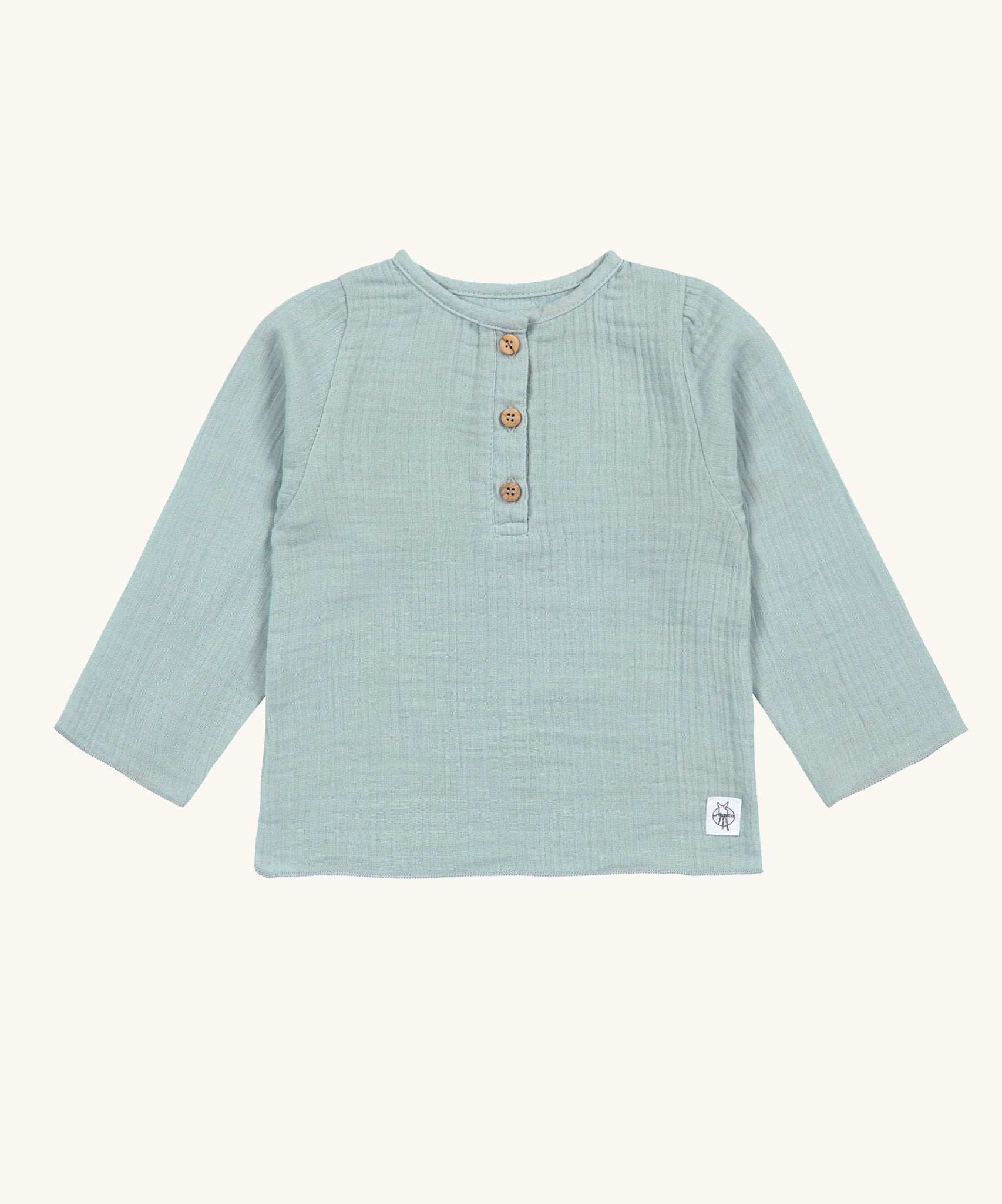 The Lassig organic cotton muslin long sleeved shirt for babies and toddlers, in a silver grey with three little brown buttons.
