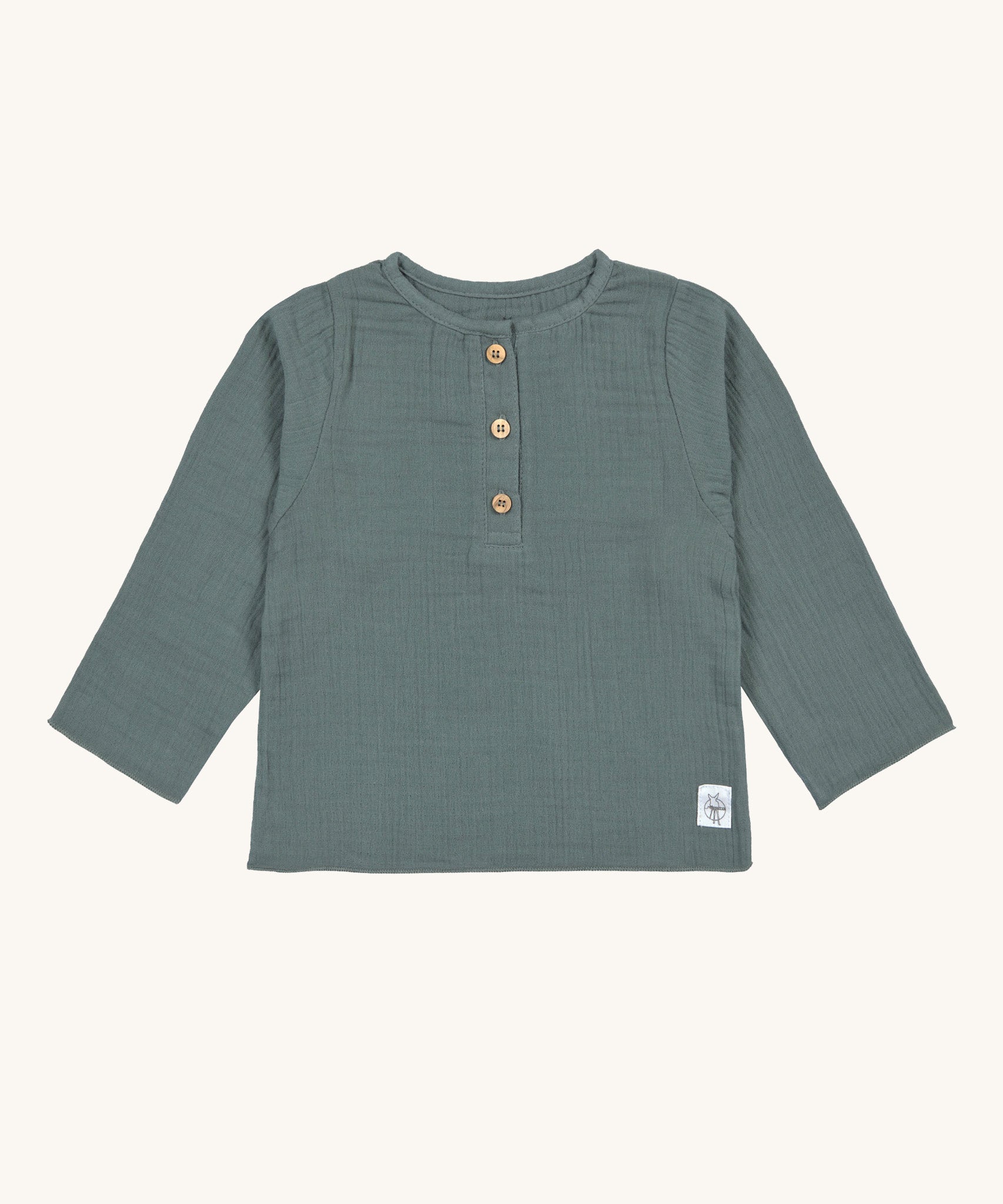 The Lassig organic cotton muslin long sleeved top for babies and toddlers, in a dark petrol green with little brown buttons.