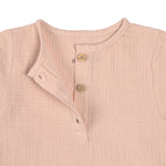 The Lassig organic cotton muslin long sleeved top for babies and toddlers, in a beautiful pale powder pink colour. Close up image shows the three small brown buttons.