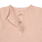 The Lassig organic cotton muslin long sleeved top for babies and toddlers, in a beautiful pale powder pink colour. Close up image shows the three small brown buttons.