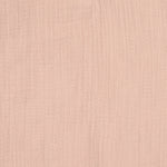 A closeup of the beautifully soft organic cotton muslin material, in a pale powder pink, from Lassig.
