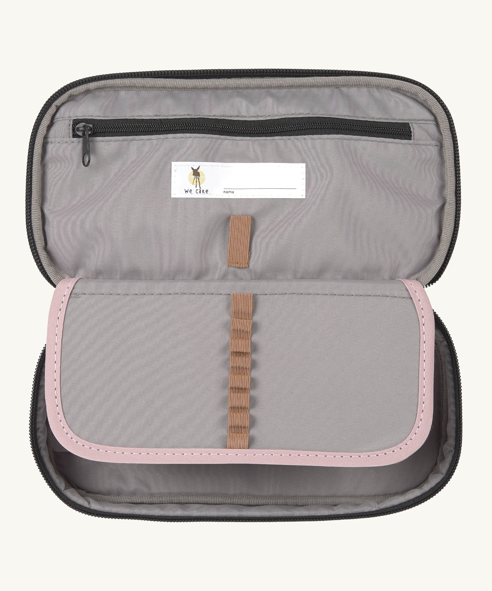 A close up of the inside of the Lassig spacy pink & navy pencil case showing the elasticated stationary holder detail and extra compartment with a zip fastener. Features a name tag on the inside