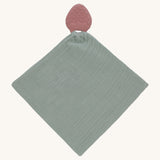 The Lassig organic cotton muslin comforter in green, with a strawberry shaped rubber teether attached to the top.