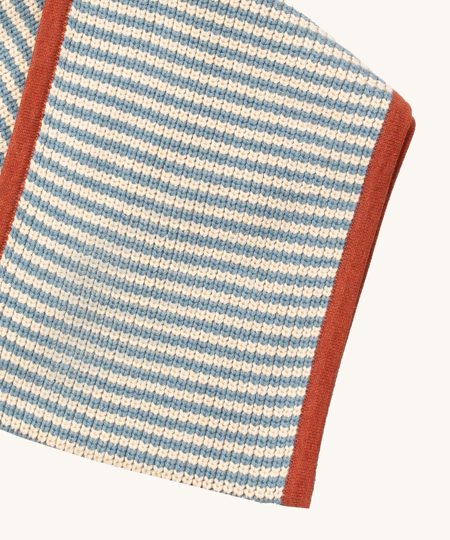 A close up of the Little Green Radicals knitted scarf in blue stripes. showing the blue and cream stripes detail on organic cotton fabric