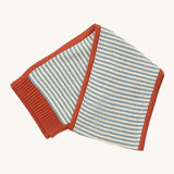 Little Green Radicals knitted scarf in blue stripes available at Babipur. A thick knitted GOTS organic cotton scarf in blue and cream stripes with a red trim