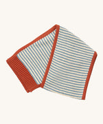 Little Green Radicals knitted scarf in blue stripes available at Babipur. A thick knitted GOTS organic cotton scarf in blue and cream stripes with a red trim