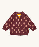 Little Green Radicals reversible easy rider jacket in brown bears. A GOTS organic cotton bomber jacket style in brown with a full length zip, pouch pockets and cute prints of brown bears. Features a yellow and white stripe reversible side
