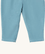 A close up of the Little Green Radicals comfy trousers in pale blue corduroy. Showing the corduroy detail on pastel blue organic cotton fabric