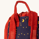 A close up of the Little Green Radicals ready for adventure backpack in dark night. Showing the handle and starry night detail on navy corduroy cotton fabric.