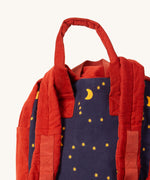 A close up of the Little Green Radicals ready for adventure backpack in dark night. Showing the handle and starry night detail on navy corduroy cotton fabric.