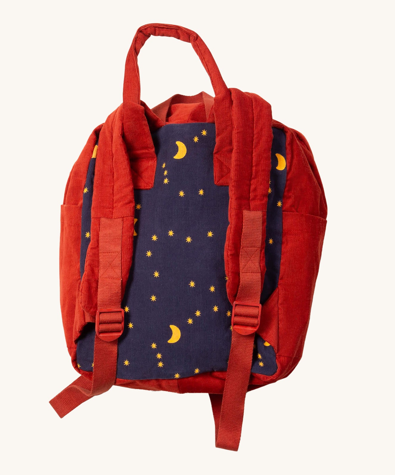 A close up of the Little Green Radicals ready for adventure backpack in dark night. Showing the red shoulder strap detail on navy and red corduroy cotton fabric.