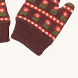 A close up of the Little Green Radicals collecting flowers mittens showing the retro red flower design and matching brown elasticated cuff detail on organic cotton fabric