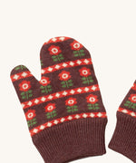 A close up of the Little Green Radicals collecting flowers mittens showing the retro red flower design on dark brown organic cotton fabric