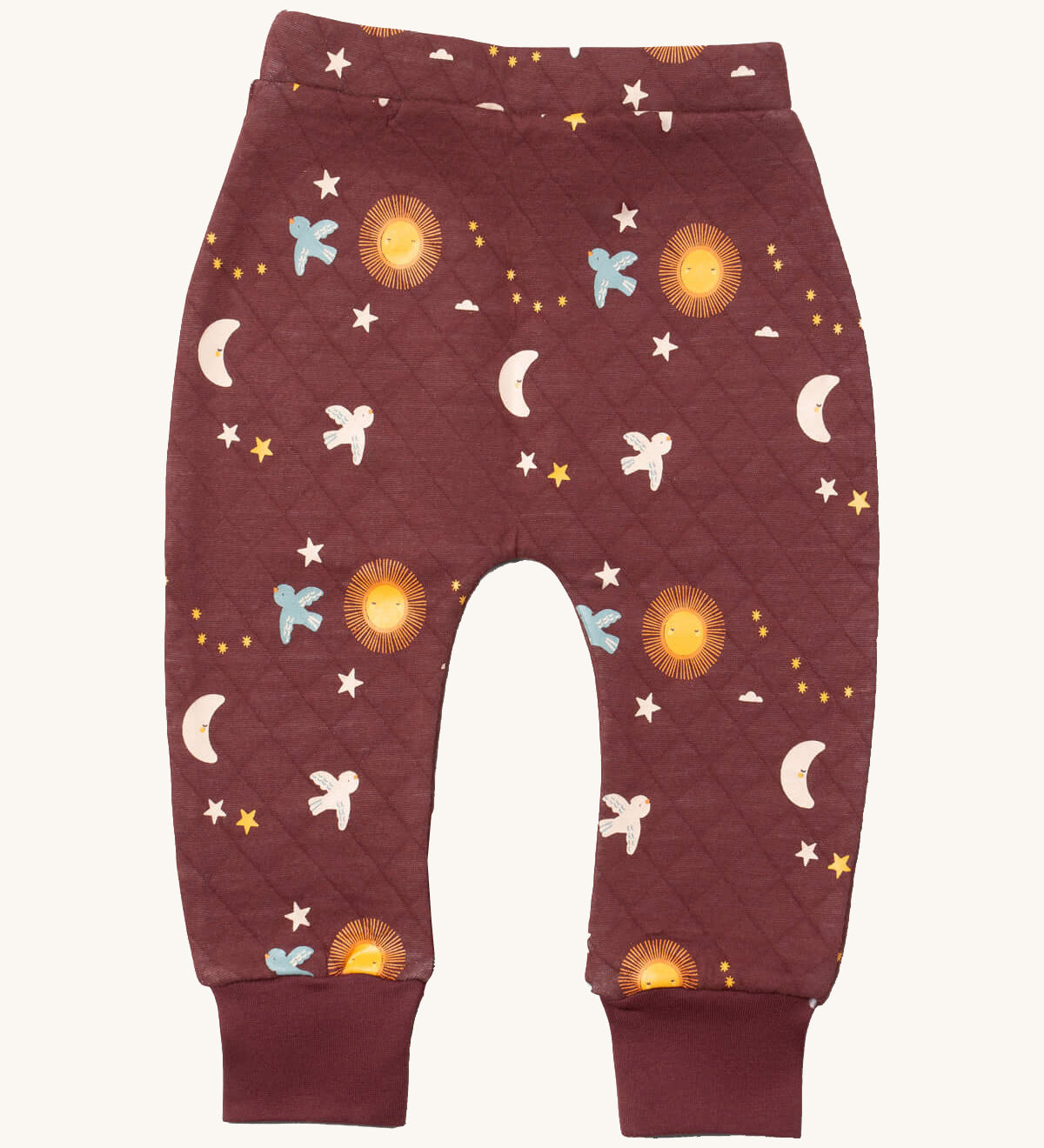 Little Green Radicals flying birds quilted joggers available at Babipur. A dark maroon GOTS organic cotton joggers with a quilted stitch with elasticated cuffs and cute prints of birds flying through a starry night