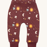 Little Green Radicals flying birds quilted joggers available at Babipur. A dark maroon GOTS organic cotton joggers with a quilted stitch with elasticated cuffs and cute prints of birds flying through a starry night