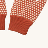 A close up of the Little Green Radicals ginger diamond mittens showing the diamond design and elasticated cuff detail on organic cotton fabric