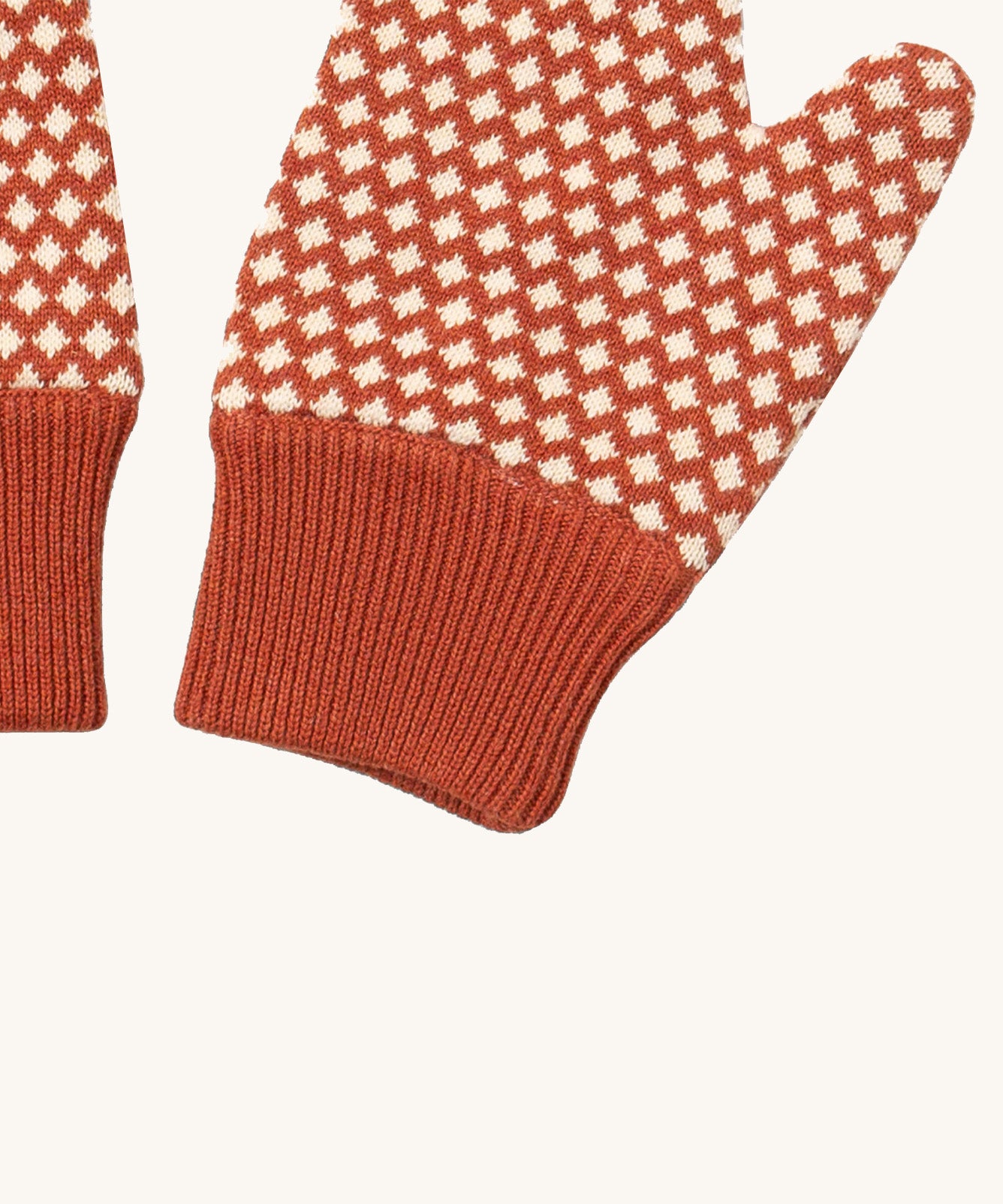 A close up of the Little Green Radicals ginger diamond mittens showing the diamond design and elasticated cuff detail on organic cotton fabric