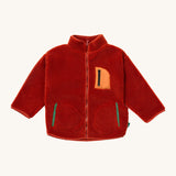 Little Green Radicals zip up fleece jacket in ginger available at Babipur. A thick sherpa fleece recycled polyester jacket in dark orange with turn up collar. Features a full length zip, a chest pocker with light orange trim and 2 side pockets