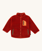Little Green Radicals zip up fleece jacket in ginger available at Babipur. A thick sherpa fleece recycled polyester jacket in dark orange with turn up collar. Features a full length zip, a chest pocker with light orange trim and 2 side pockets