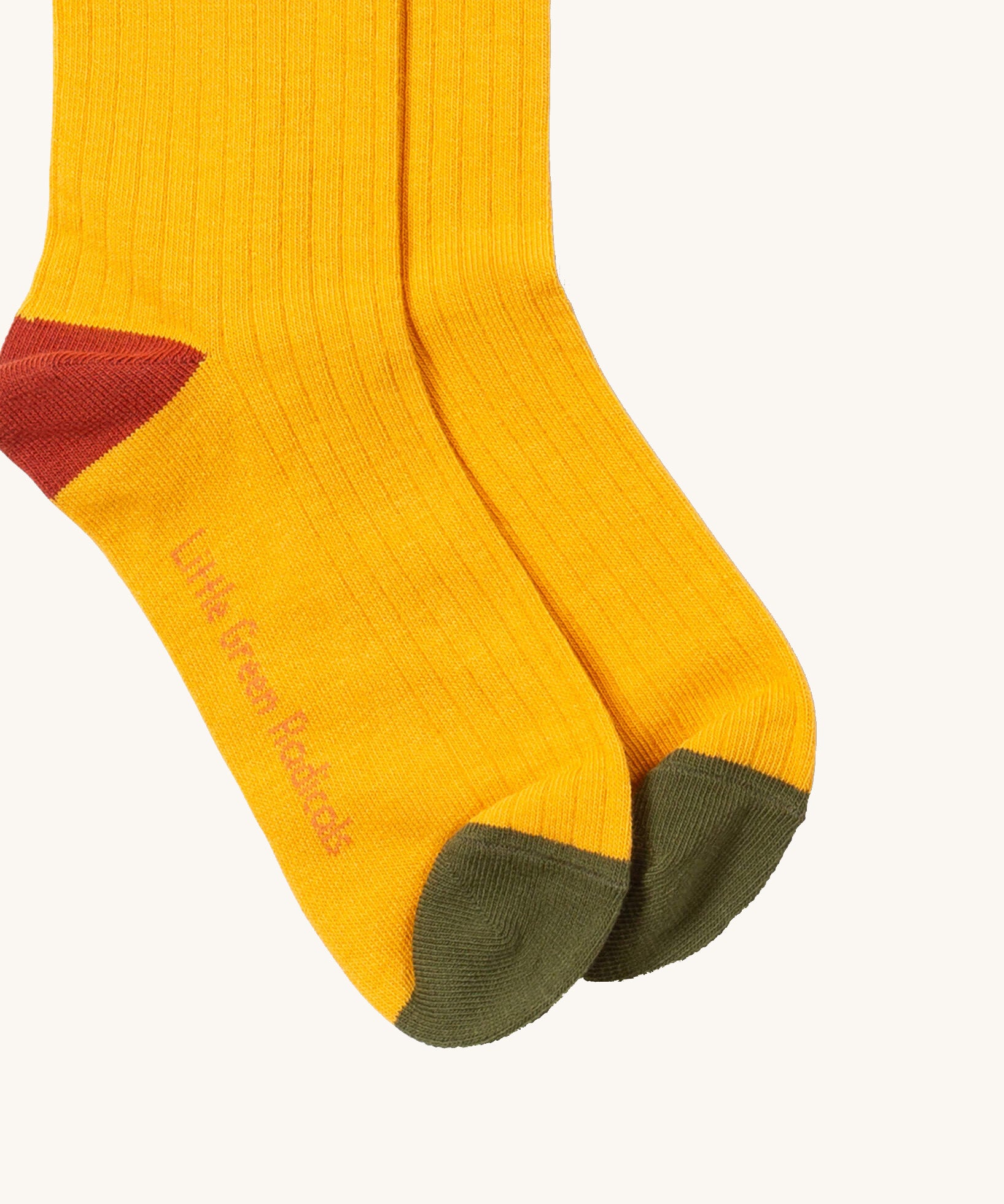 Little Green Radicals yellow block ankle socks from the winter rabbit set available at Babipur. A GOTS organic cotton sock with green and red trim with the brand name on the sole