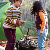 2 children playing with sticks in woodland wearing the Little Green Radicals comfy corduroy trousers in chocolate and pale blue