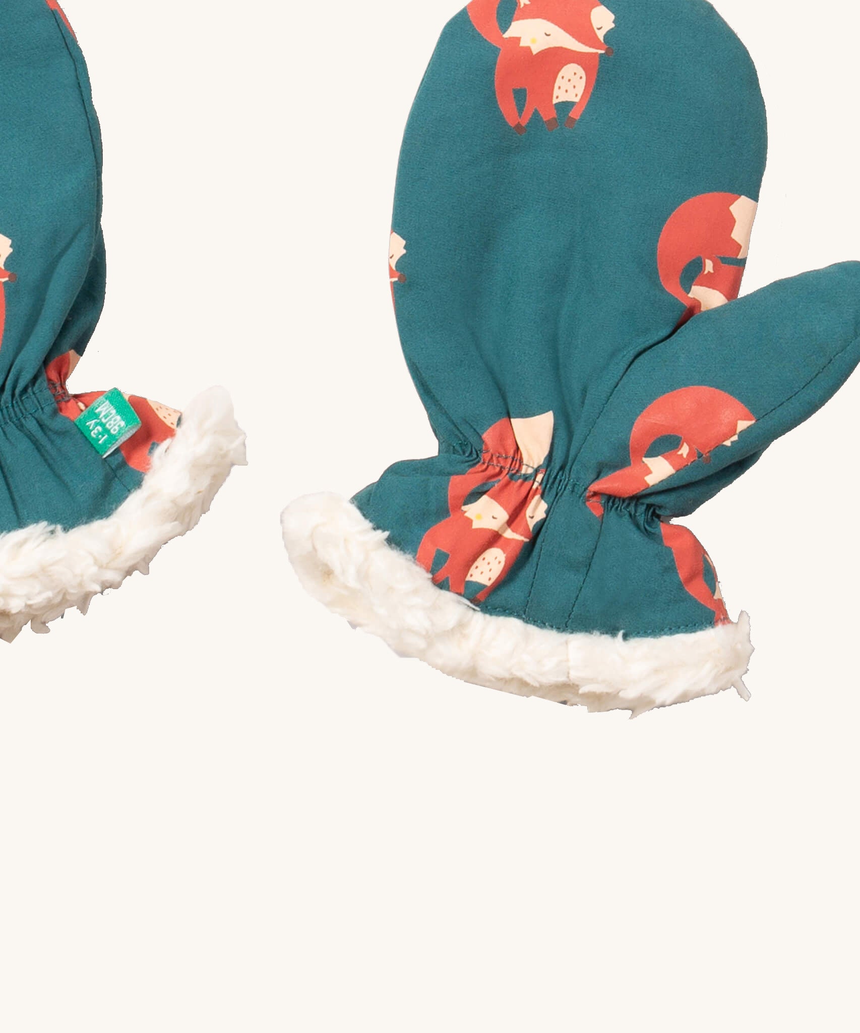 A close of the Little Green Radicals sherpa fleece mittens in foxes. Showing a close up of the fox print and soft elasticated cuff around the wrist for a secure fit  on turquoise organic cotton fabric.