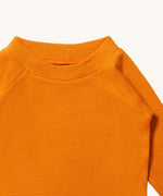 A close up of LGR Long Sleeve Waffle Top - Golden Ochre showing the waffle texture and collar detail on yellow organic cotton fabric