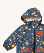 A close up of the Little Green Radicals waterproof adventure coat in night moon showing the sherpa fleece liner, the full length zip and 2 side pockets in red trim detail on navy recycled polyester fabric