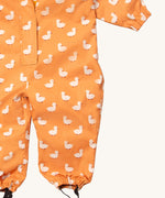 A close up of the Little Green Radicals gold ducks waterproof winter suit. Showing the elasticated cuffs detail for a snug fit on yellow recycled polyester fabric