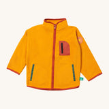 Little Green Radicals polar fleece jacket in gold available at Babipur. A dark yellow recycled polyester fleece with red trim. Features a chest and 2 side pockets and a sun appliqué patch on the left shoulder