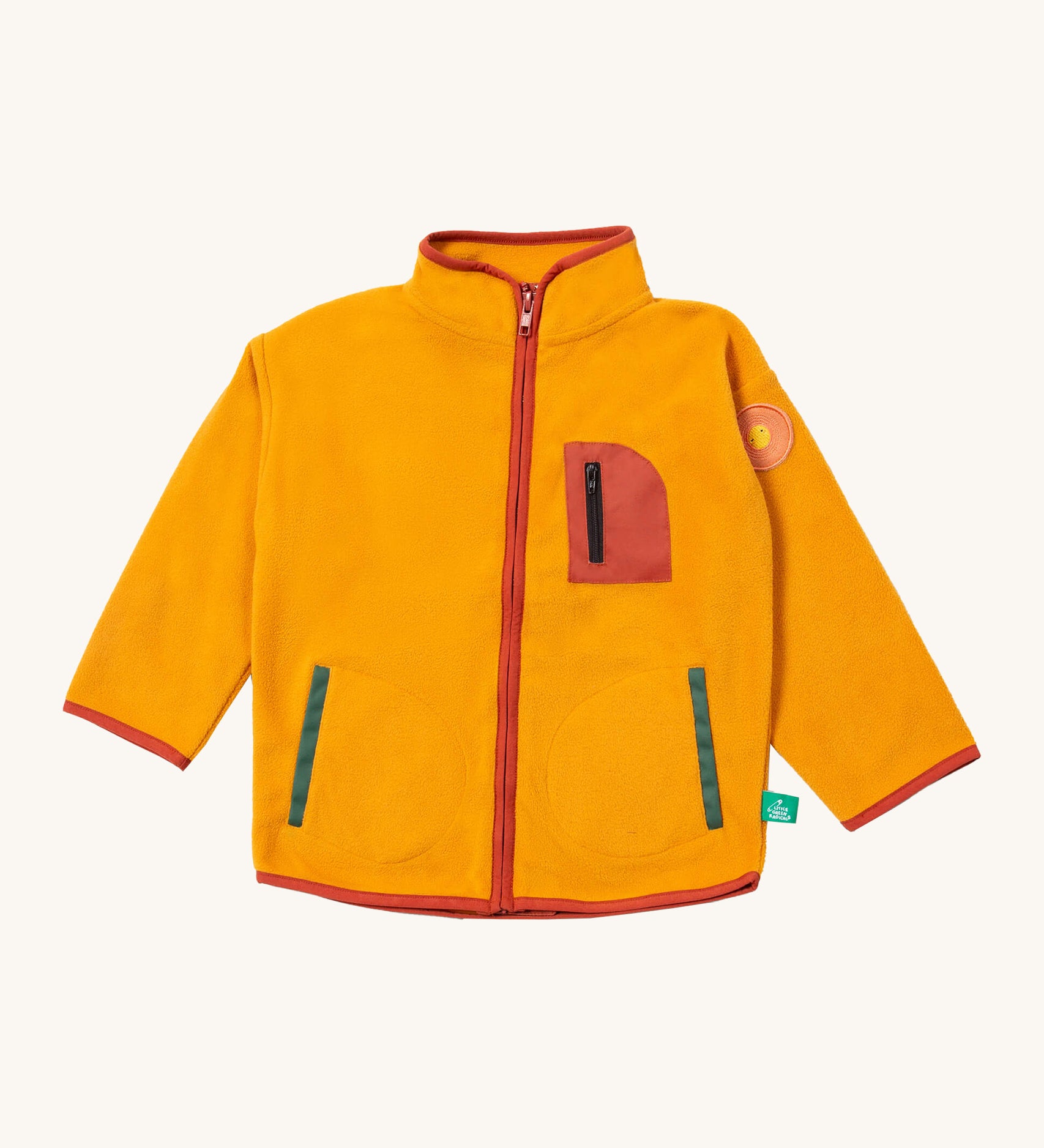 Little Green Radicals polar fleece jacket in gold available at Babipur. A dark yellow recycled polyester fleece with red trim. Features a chest and 2 side pockets and a sun appliqué patch on the left shoulder