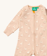 A close up of the Little Green Radicals puddle ducks baby grow, showing the full length zip detail on link pink organic cotton fabric.