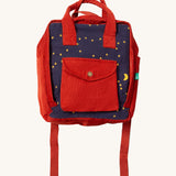 Little Green Radicals ready for adventure backpack in dark night available at Babipur. A 100% organic cotton backpack in a navy and red corduroy style with a starry night design. Features a handle on the top for easy carrying a front pocket and 2 bottle holders