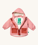 Little Green Radicals waterproof coat in coral available at Babipur. A thick pink with dark pink trim winter's coat made from recycled polyester. Features a sherpa fleece inner liner, elasticated arm cuffs for a snug fit and a full length zip  with a sherpa fleece inner liner