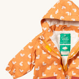 A close up of the Little Green Radicals waterproof coat in gold ducks showing the hood detail with sherpa fleece liner and name patch detail on yellow recycled polyester fabric