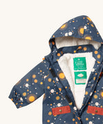 A close up of the Little Green Radicals waterproof coat in night moon showing the hood detail with sherpa fleece liner and name patch detail on navy recycled polyester fabric