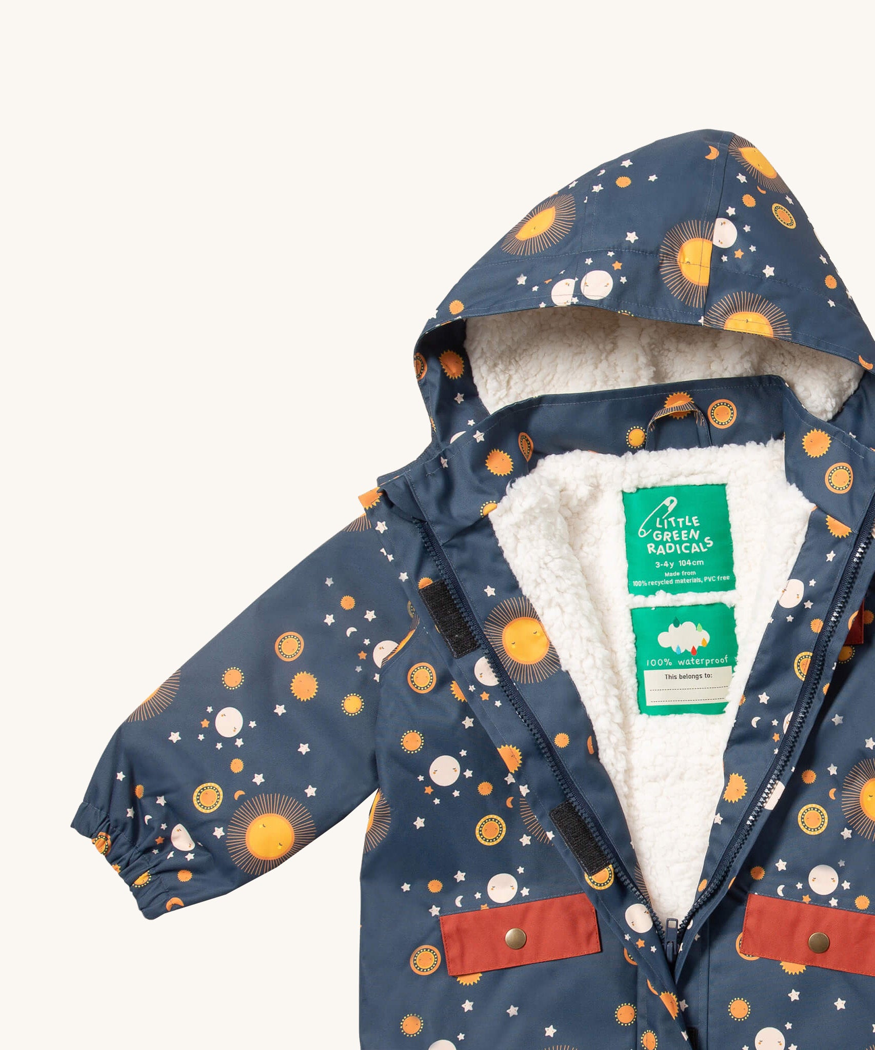A close up of the Little Green Radicals waterproof coat in night moon showing the hood detail with sherpa fleece liner and name patch detail on navy recycled polyester fabric