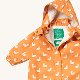 A close up of the Little Green Radicals gold ducks waterproof winter suit. Showing the sherpa fleece inner liner detail under the hood and 1/2 length zip detail and name patch stitched on the inside on yellow recycled polyester fabric.