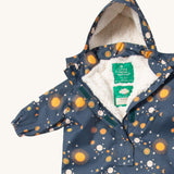 A close up of the Little Green Radicals night moon waterproof winter suit. Showing the sherpa fleece inner liner detail under the hood and 1/2 length zip detail and name patch stitched on the inside on navy recycled polyester fabric.