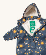 A close up of the Little Green Radicals night moon waterproof winter suit. Showing the sherpa fleece inner liner detail under the hood and 1/2 length zip detail and name patch stitched on the inside on navy recycled polyester fabric.