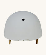 Maël Diffuser, a light grey dome plug-in essential oil diffuser with wooden feet.