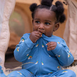 A child wearing the Little Green Radicals Blue Rainbows Zip Organic Babygrow. Little green Radicals have a wide range of organic cotton, Fairtrade clothing and outerwear for babies and children available here at Babipur.
