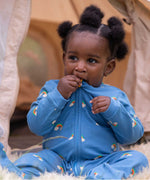 A child wearing the Little Green Radicals Blue Rainbows Zip Organic Babygrow. Little green Radicals have a wide range of organic cotton, Fairtrade clothing and outerwear for babies and children available here at Babipur.