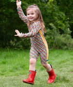 A child wearing the Little Green Radicals Vintage Flowers UPF 50+ Recycled Sunsafe Sunsuit with a pair of red wellington boots.