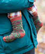 A close up of the winter rabbits design socks on a child's feet. Little Green Radicals Ankle Socks 3 Pack - Winter Rabbits. The organic cotton children's socks are a part of a wide range of organic cotton clothing for children available here at Babipur.