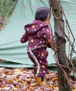 A child wearing the Little Green Radicals Organic Cotton Flying Birds Quilted Snug Suit. A maroon brown coloured suit with an all over print featuring flying birds, stars, moon and  sun. This snug suit is a part of a wide range of organic cotton clothing for children available here at Babipur.